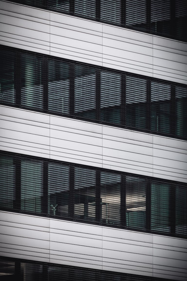 Abstract view of modern office building facade with reflecting glass windows in Hamburg, Germany.